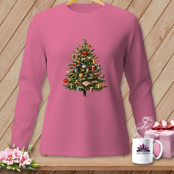 Pink long-sleeve shirt with a Christmas tree decorated with sewing notions.