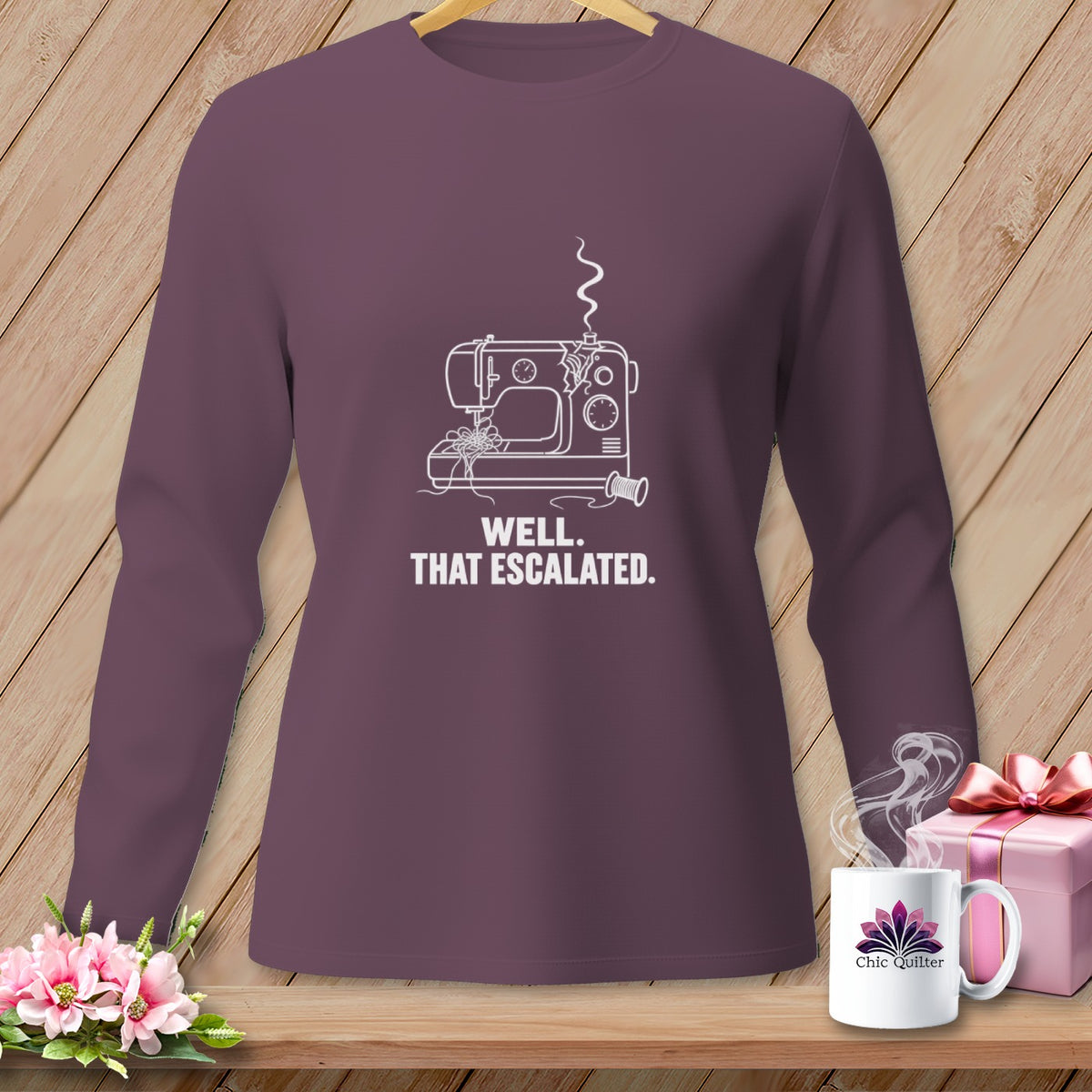 Purple long-sleeve shirt with a white line drawing of a sewing machine and text.