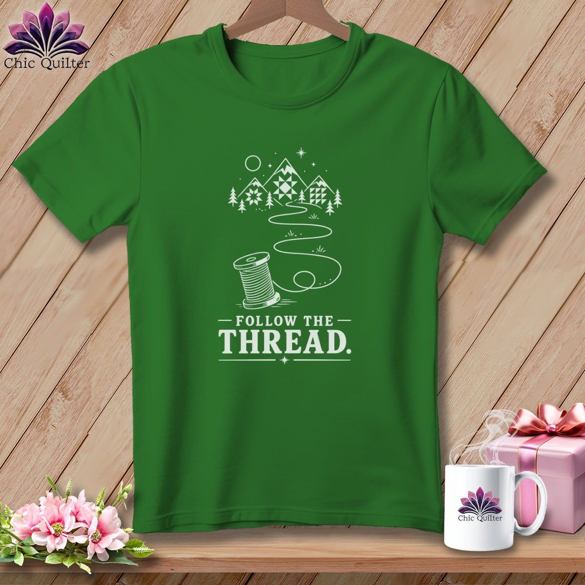 Green t-shirt with a spool of thread design and "Follow the Thread" text.