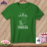 Green t-shirt with a spool of thread design and 