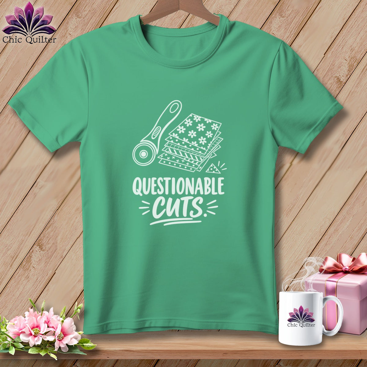 Green t-shirt with rotary cutter, fabric scraps, and text "QUESTIONABLE CUTS".