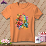 An orange short-sleeved t-shirt features a colorful watercolor thimble graphic surrounded by flowers and paint splatters.