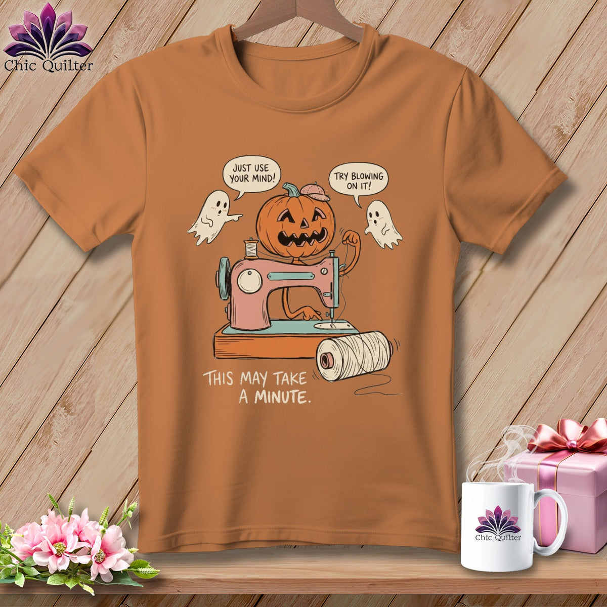 Halloween pumpkin sewing on a machine with ghosts, reads "This may take a minute".