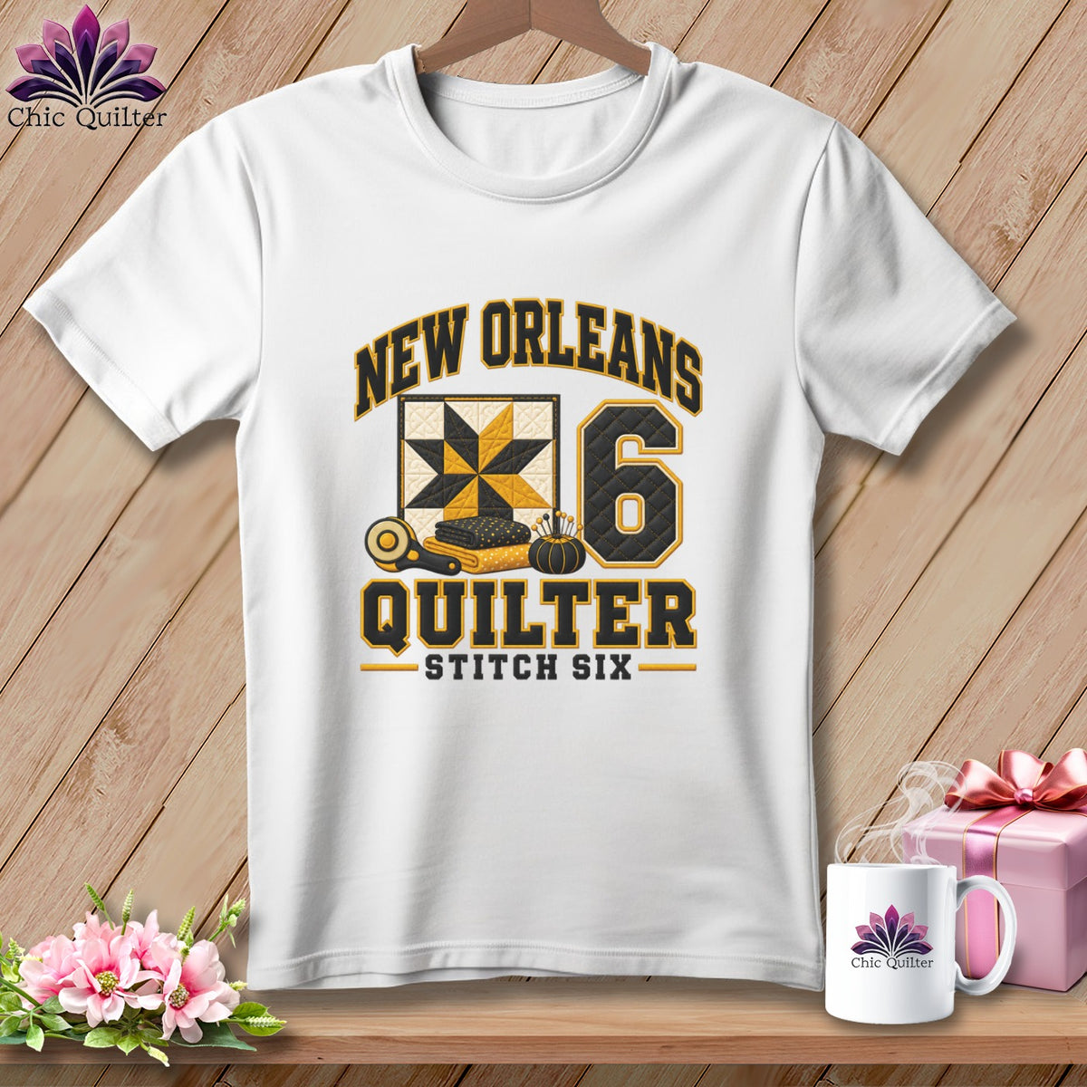 White t-shirt featuring a New Orleans Quilter design with a yellow and black quilt block and number six.