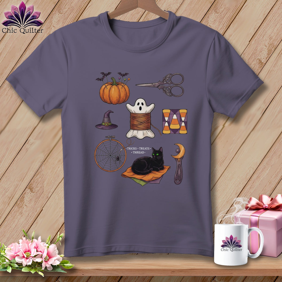 T-shirt with Halloween sewing motifs: pumpkin, ghost, cat, needlework tools, and candy corn.