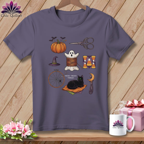 T-shirt with Halloween sewing motifs: pumpkin, ghost, cat, needlework tools, and candy corn.