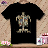 Black t-shirt with skeleton torso filled with fabric, scissors, and pumpkin. 
