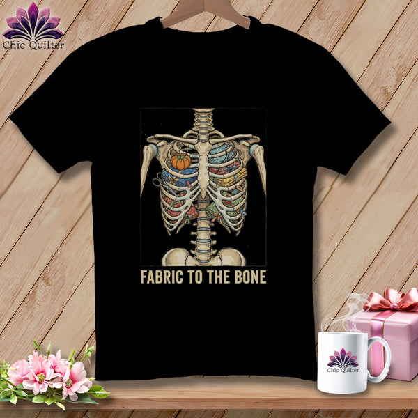 Black t-shirt with skeleton torso filled with fabric, scissors, and pumpkin. "Fabric to the Bone" text.