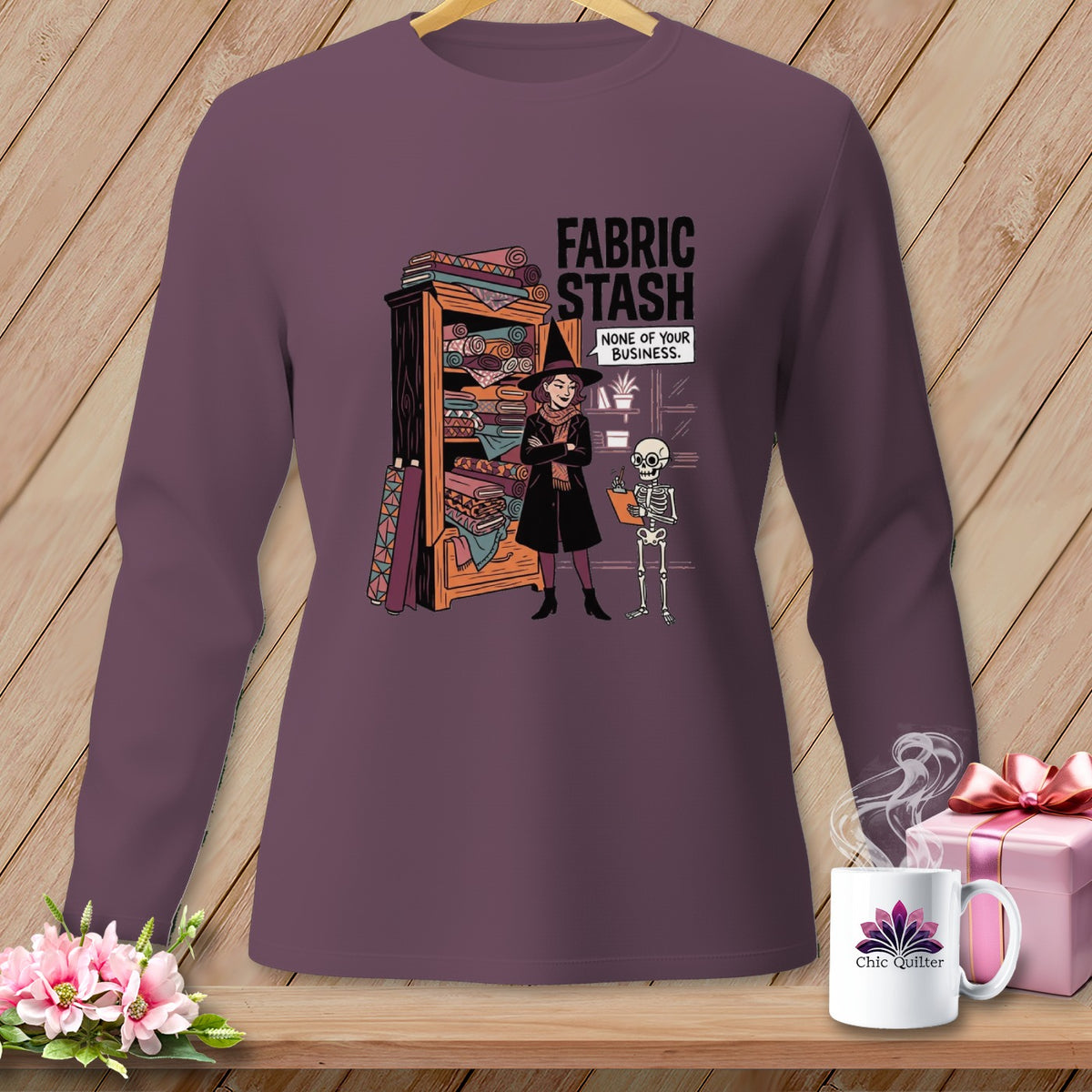 Illustration of witch and skeleton with "Fabric Stash None of Your Business" text.