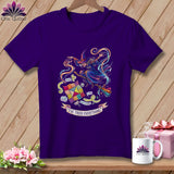 Purple t-shirt with a witch illustration, patchwork squares, and text 