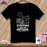 Black t-shirt with sewing machine, fabric stack, and text 