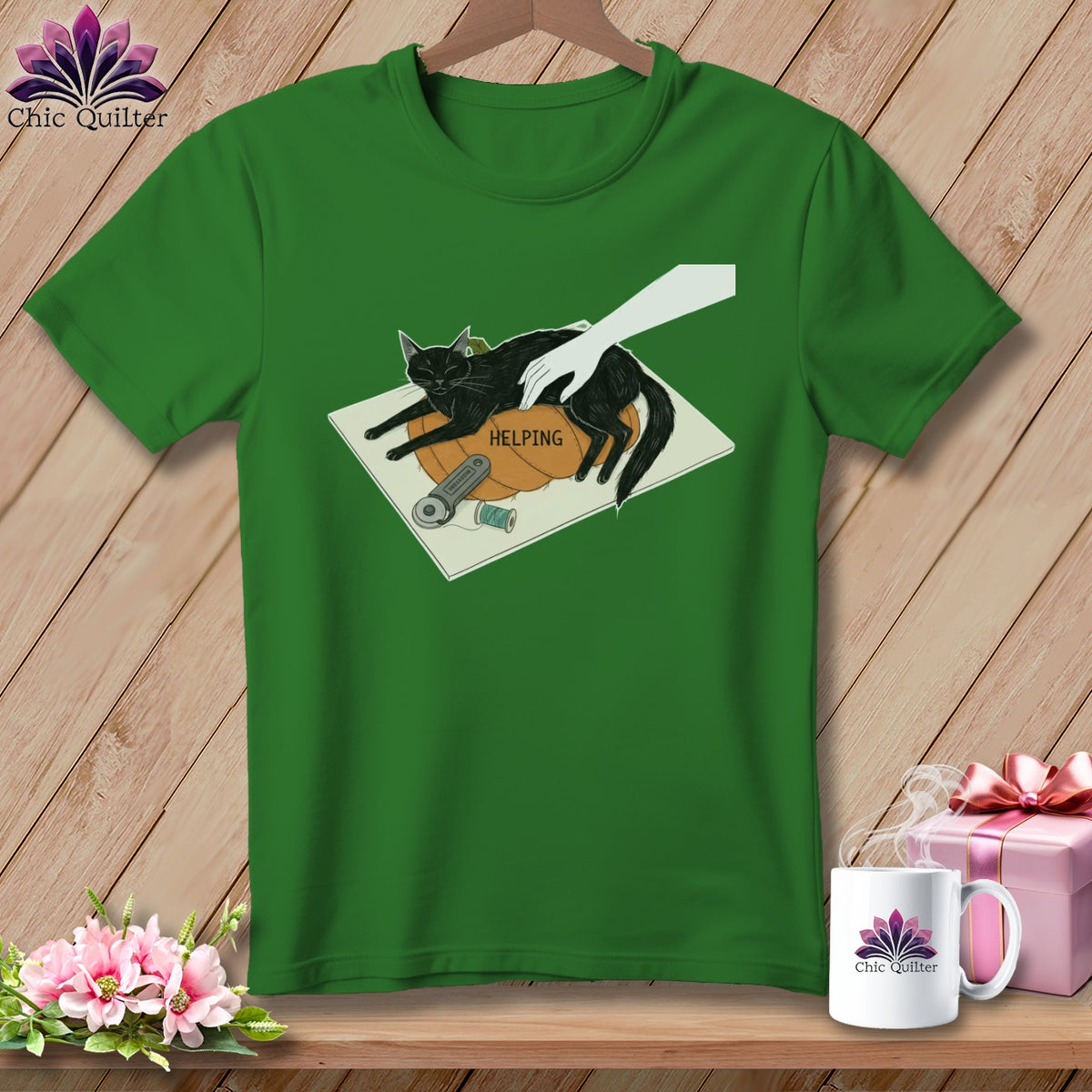 Green t-shirt with a black cat on a pumpkin and the word HELPING.