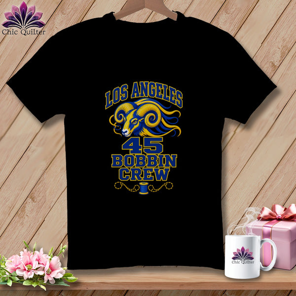 A black t-shirt featuring a blue and yellow ram graphic with text reading Los Angeles 45 Bobbin Crew.