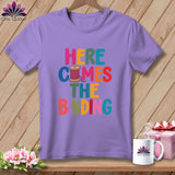 A purple crewneck t-shirt featuring colorful block text reading 