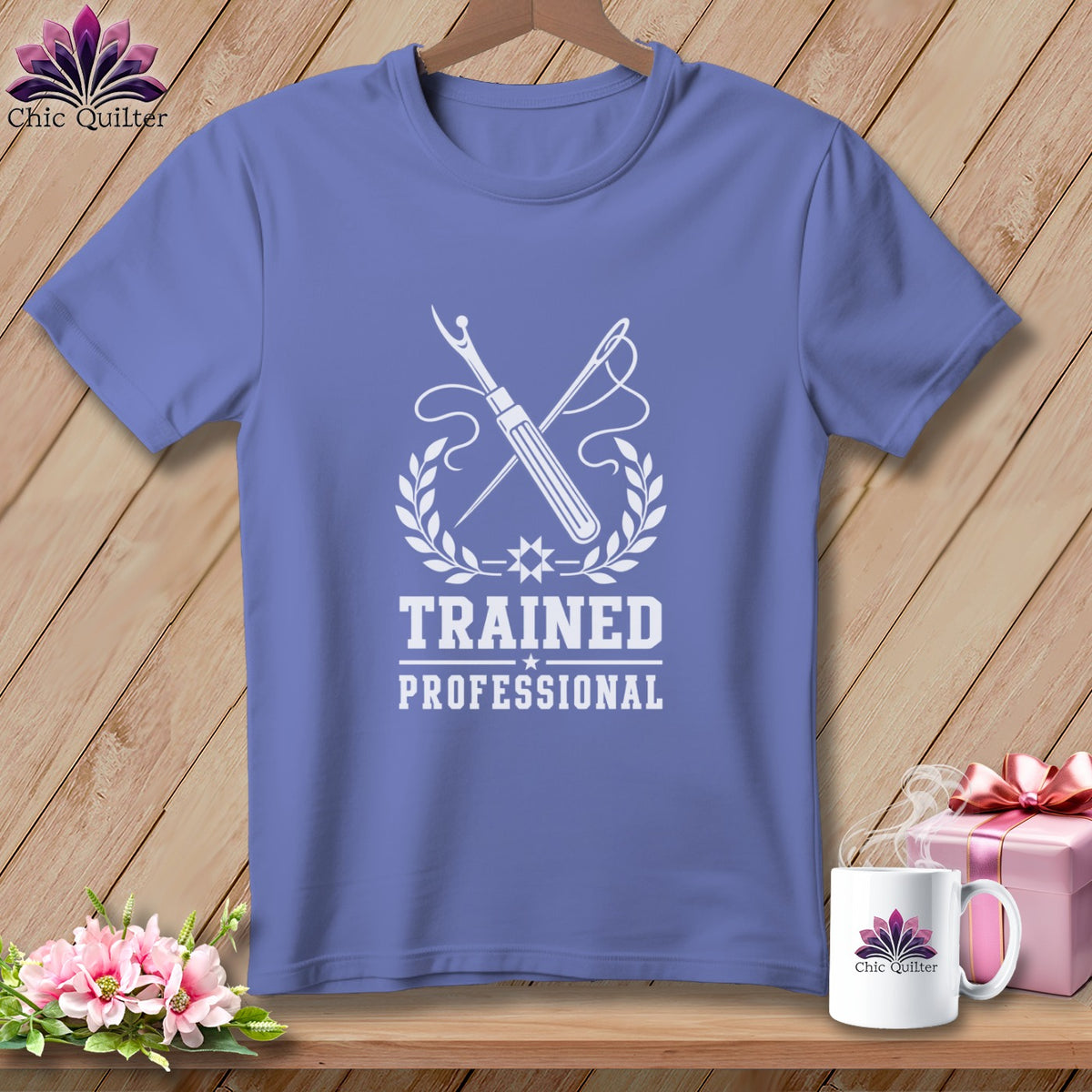 T-shirt with "Trained Professional" text, sewing tools, and laurel wreath emblem.