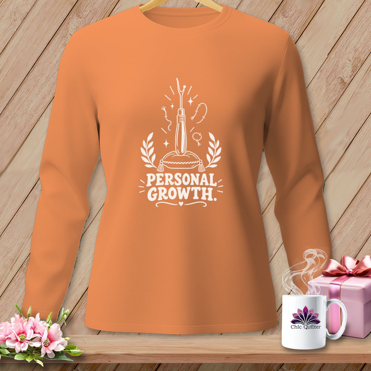Orange long-sleeve shirt with "Personal Growth" graphic and sewing motif.
