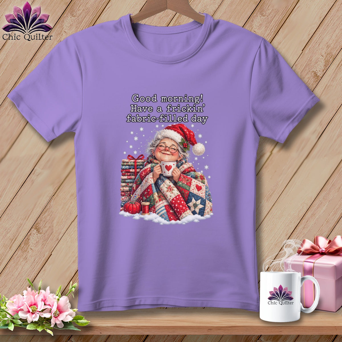 A purple short-sleeved t-shirt featuring a smiling older woman holding a mug beneath text reading Good morning Have a frickin fabric-filled day.