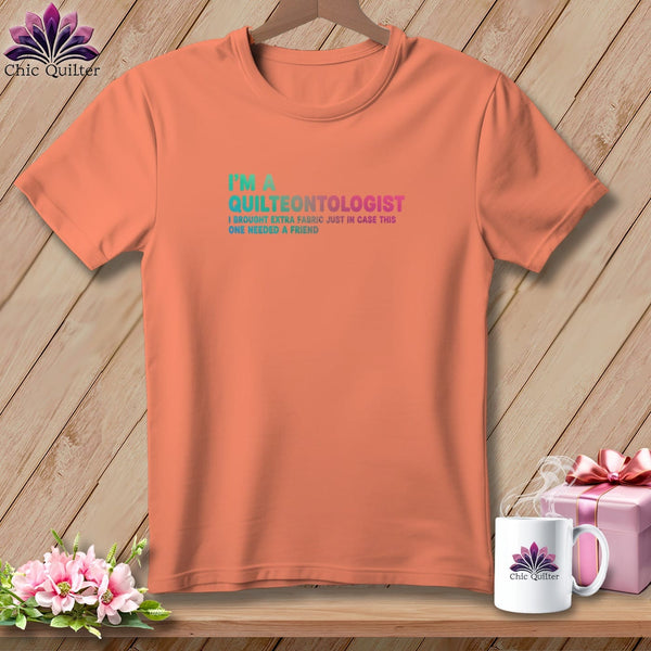 Orange t-shirt with "I'm a Quilteontologist" and fabric quote.