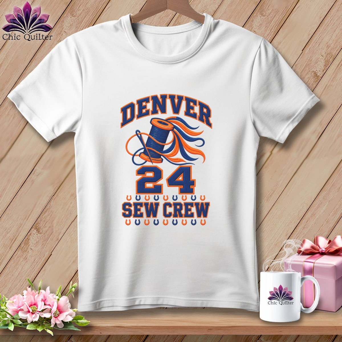 White t-shirt featuring a blue and orange sewing graphic with text that reads Denver 24 Sew Crew.