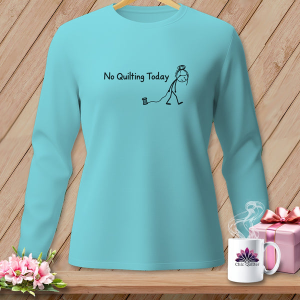 Aqua long-sleeve shirt with "No Quilting Today" and stick figure on wood background.