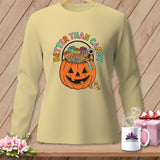 Light yellow long-sleeve shirt with a jack-o'-lantern filled with spools of thread.