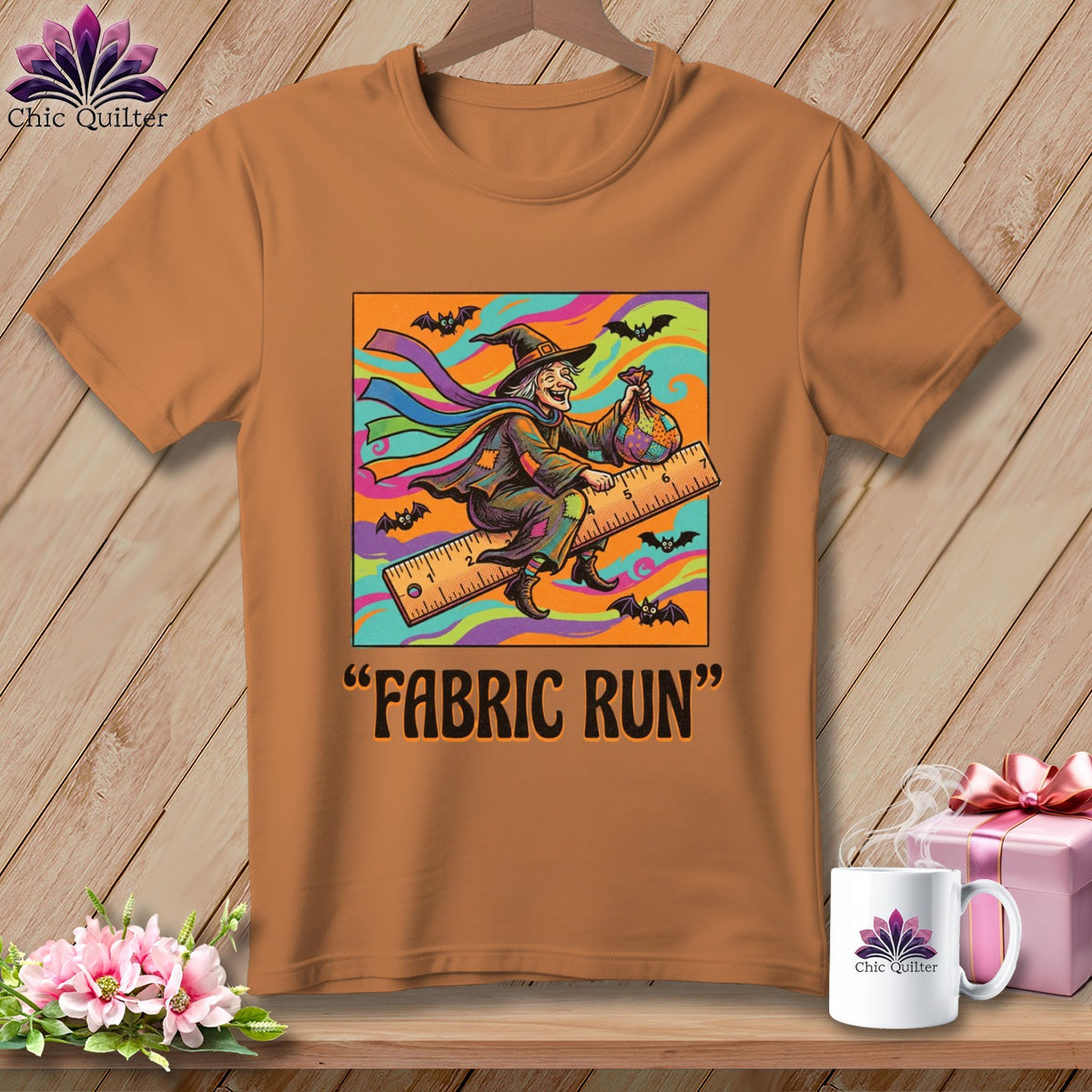 Graphic t-shirt with witch on a ruler, "Fabric Run" text, and bats.