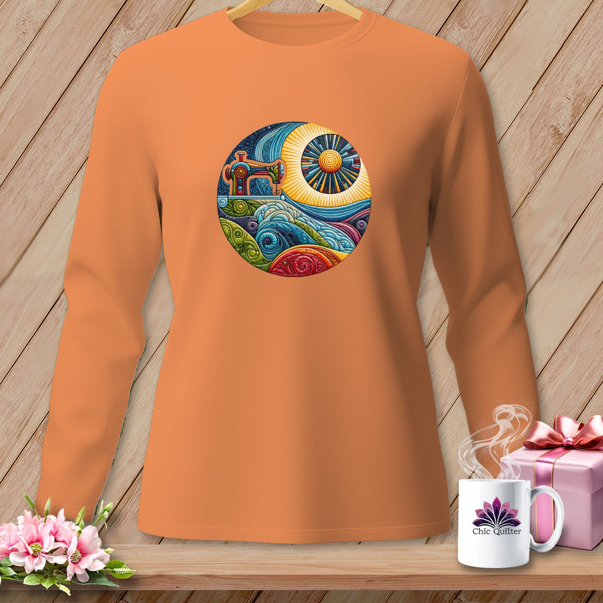 Orange long-sleeve shirt with a circular sewing machine and landscape graphic.