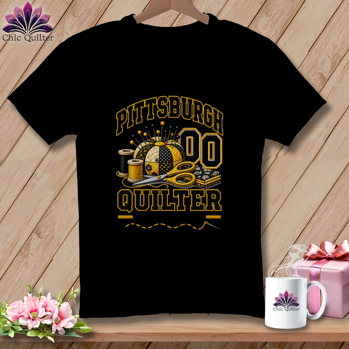 Black t-shirt featuring a yellow and black Pittsburgh Quilter graphic with a pincushion, scissors, and spools of thread.