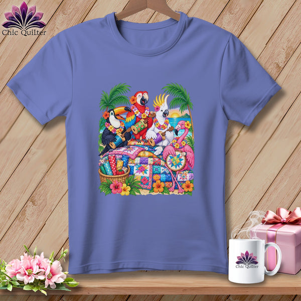 Periwinkle t-shirt featuring a colorful graphic of tropical birds playing ukuleles among quilts.