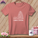 Coral t-shirt with white graphic of stacked fabric and pile of fabric scraps, reads 