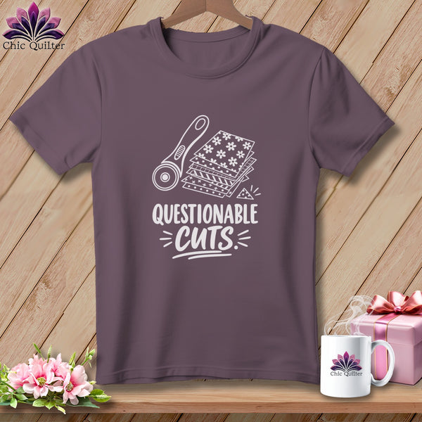 T-shirt with rotary cutter and fabric stack graphic, "Questionable Cuts" text.