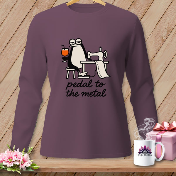 Purple long-sleeve shirt with a penguin sewing and the text "pedal to the metal".