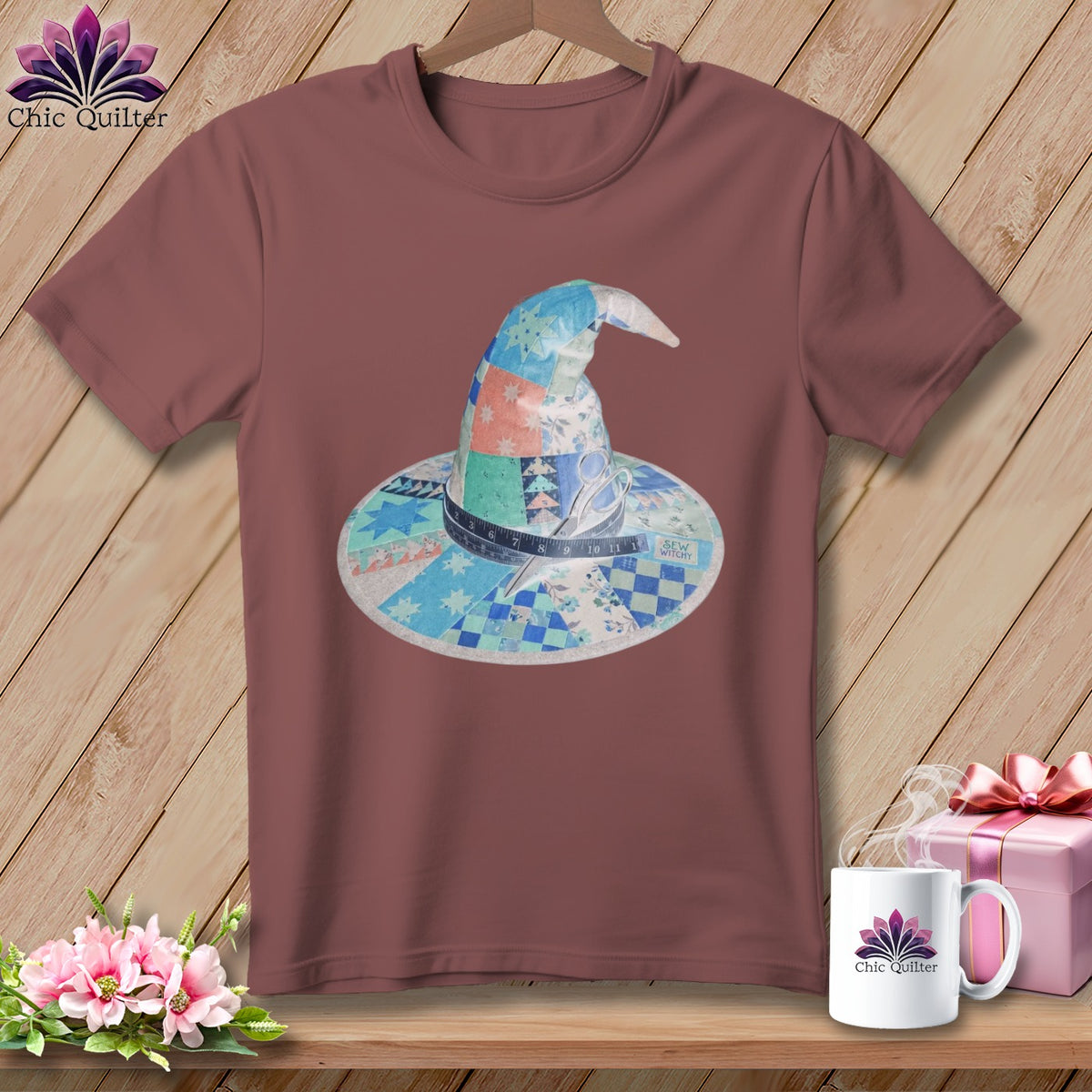 Quilted witch hat graphic with sewing notions on a maroon t-shirt.