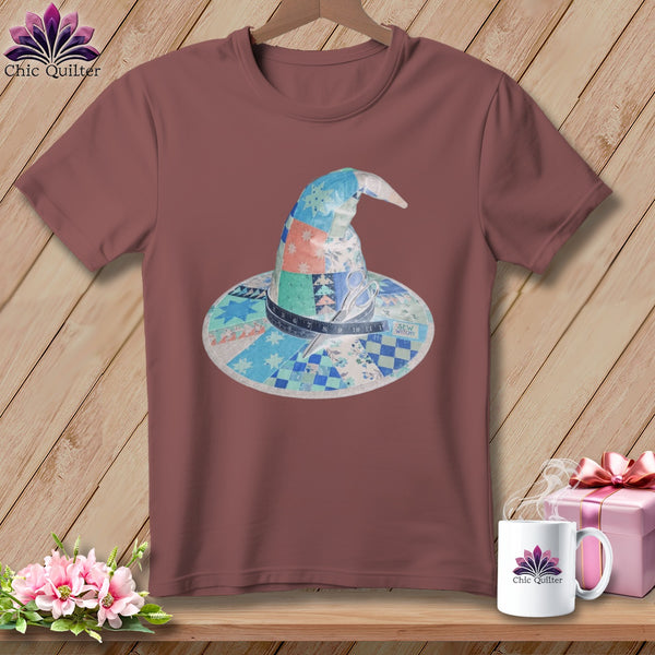Quilted witch hat graphic with sewing notions on a maroon t-shirt.