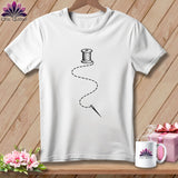 White t-shirt with a black spool of thread and needle graphic and dashed line.