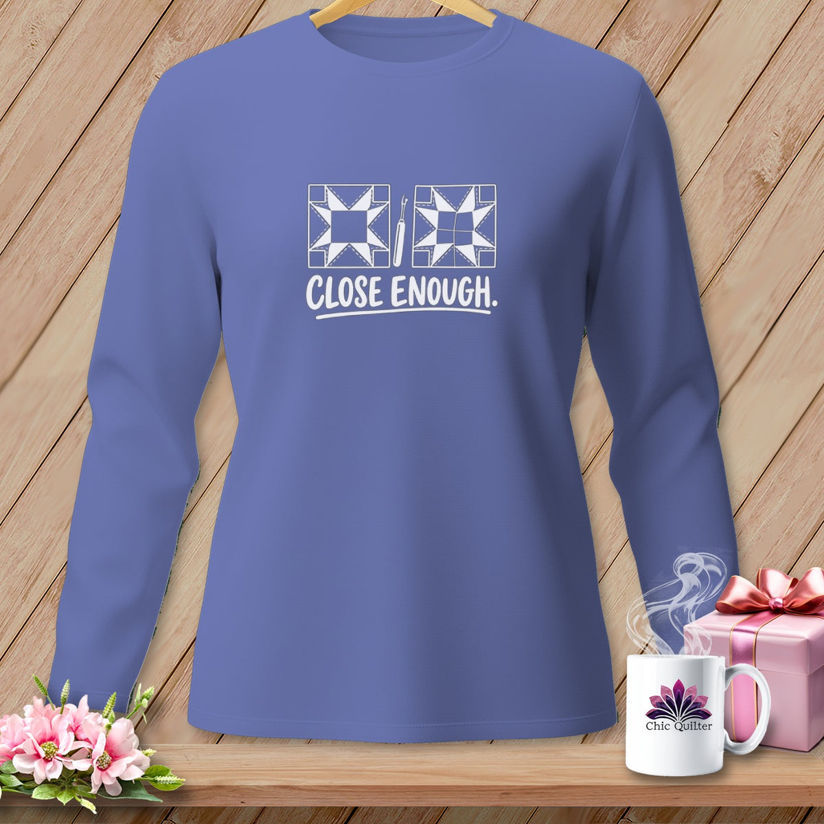 Purple long-sleeve shirt with "CLOSE ENOUGH." text and quilt block graphics.