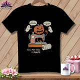 Black t-shirt with jack-o'-lantern, ghosts, and sewing machine graphic.