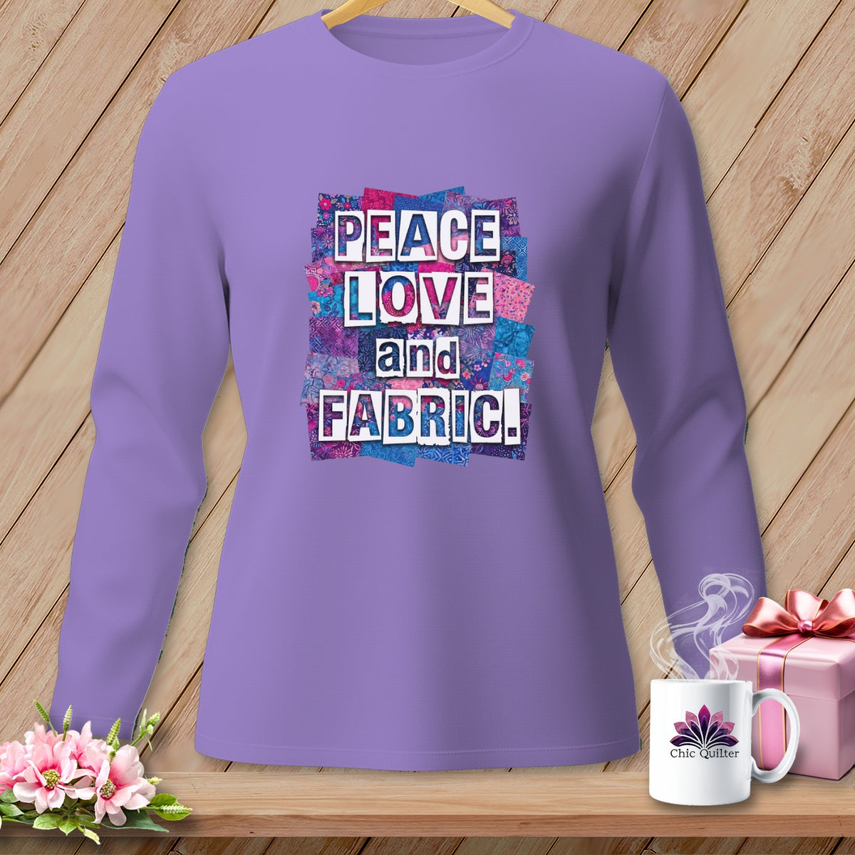 Long-sleeve lavender shirt with "Peace Love and Fabric" text on a colorful patchwork background.