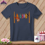 Dark navy t-shirt with a colorful illustration of bats hanging from a clothesline.