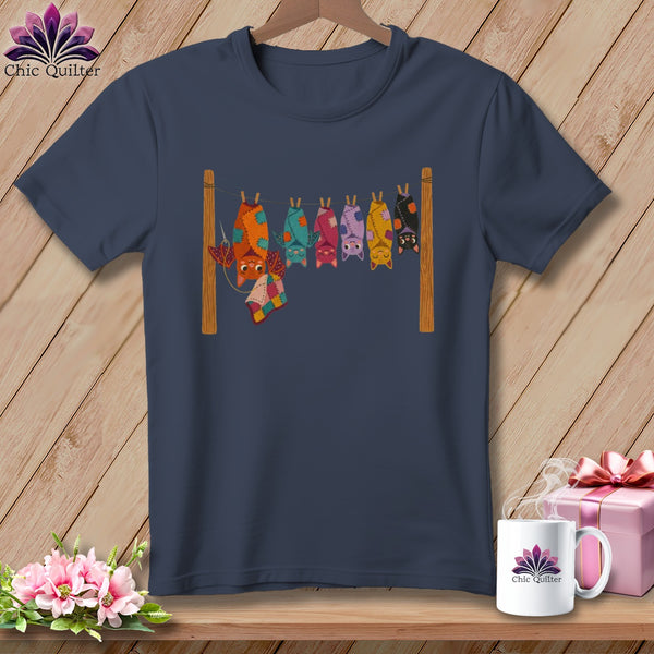 Dark navy t-shirt with a colorful illustration of bats hanging from a clothesline.
