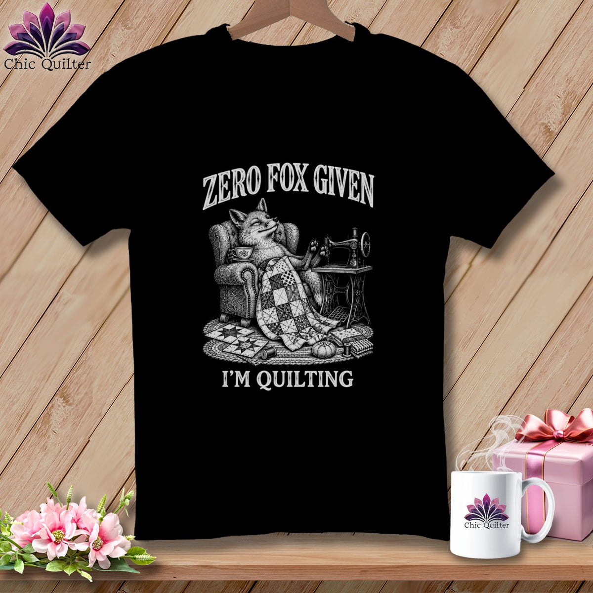 Black t-shirt with a drawing of a fox sewing, text says "Zero Fox Given I'm Quilting".