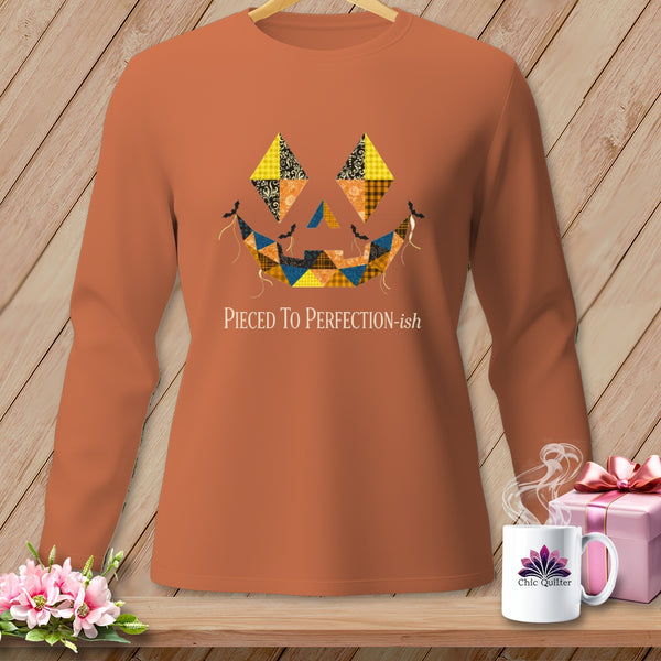 Orange long-sleeve shirt with a quilted jack-o'-lantern face graphic and "Pieced To Perfection-ish" text.