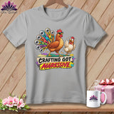 T-shirt with cartoon chickens, one with a rotary cutter tail, saying 