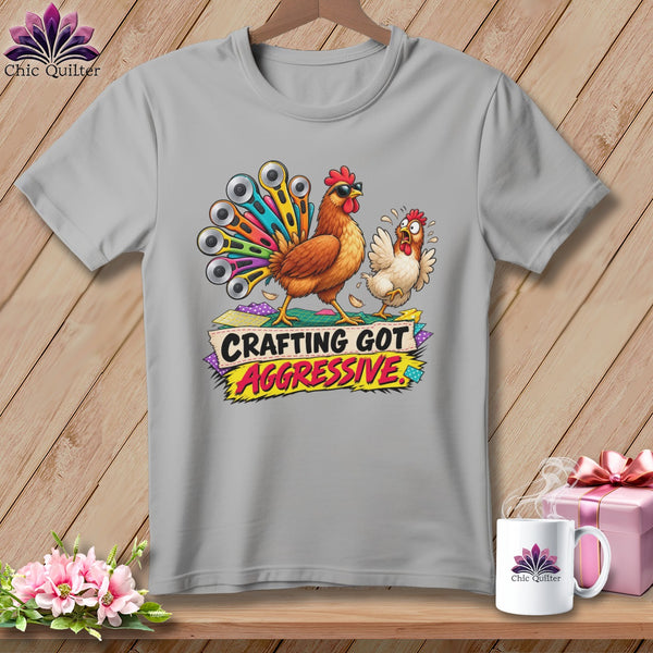 T-shirt with cartoon chickens, one with a rotary cutter tail, saying "Crafting Got Aggressive."