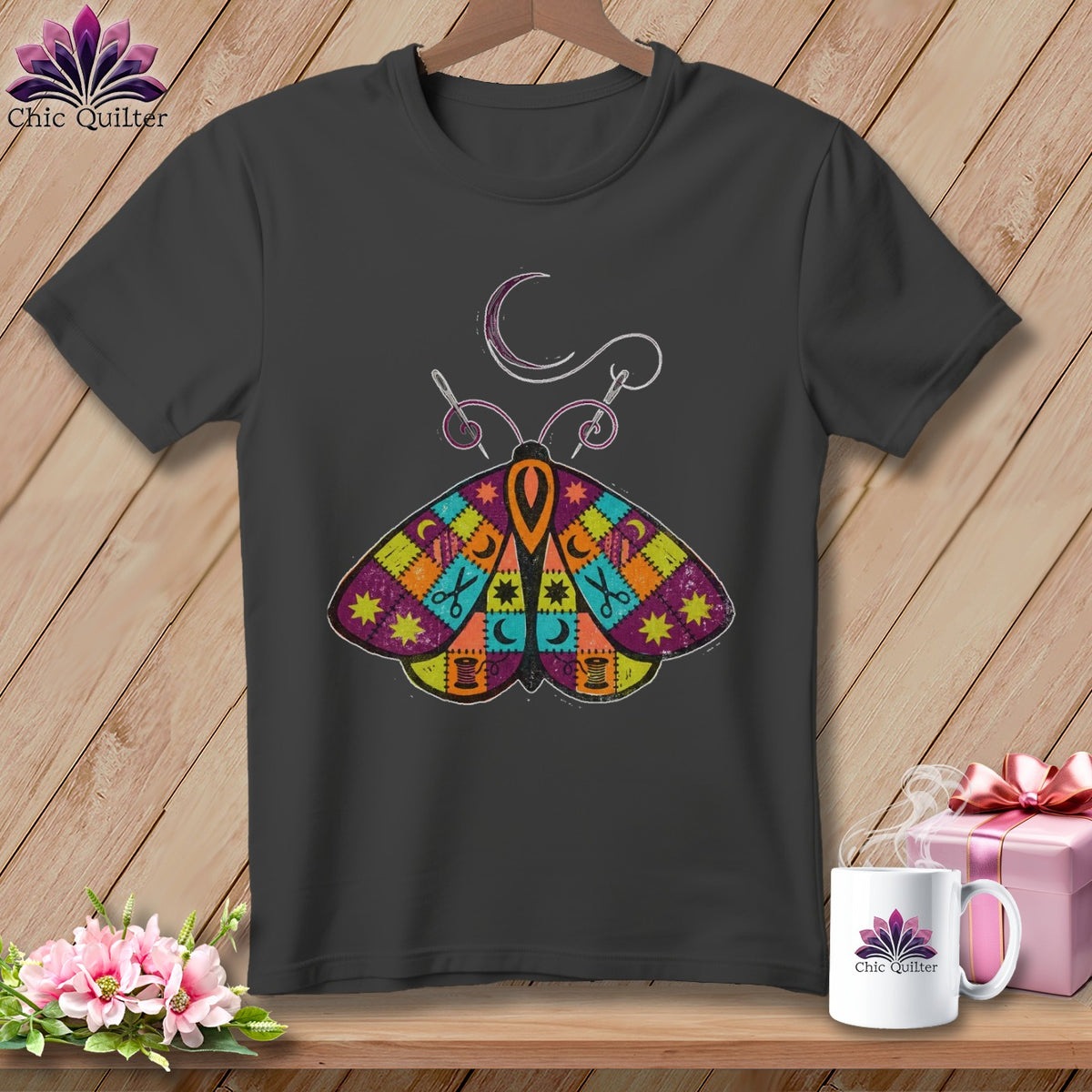 Dark gray t-shirt with a colorful patchwork moth design and sewing accents.