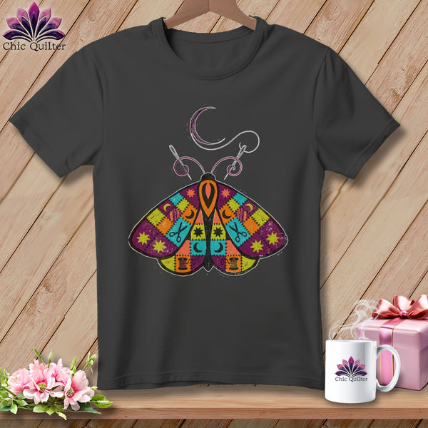 Dark gray t-shirt with a colorful patchwork moth design and sewing accents.