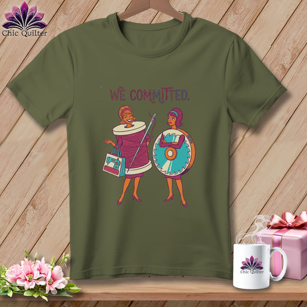 Green t-shirt with "WE COMMITTED." text and cartoon sewing theme.