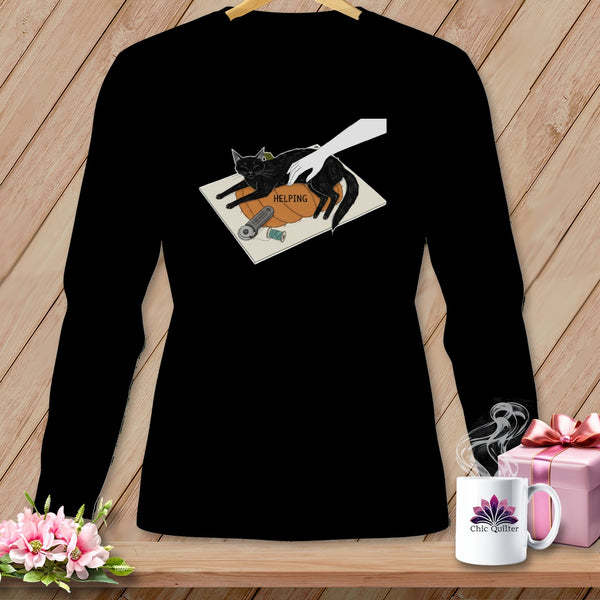 Black long sleeve shirt with a graphic of a cat, a hand, and sewing supplies.