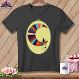 Dark gray t-shirt with a crescent moon made of colorful fabric scraps and two witches.