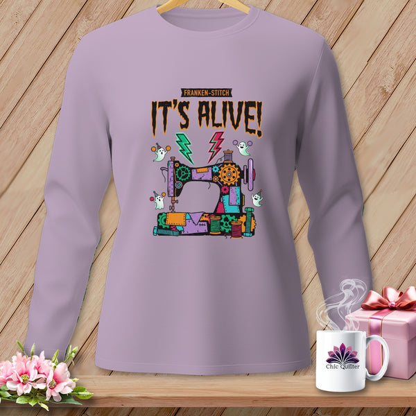 Long-sleeve shirt with a Franken-stitch sewing machine and ghosts graphic that says "IT'S ALIVE!".